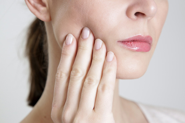 Close up of a woman with facial pain at Peak Endodontics in Covington, WA